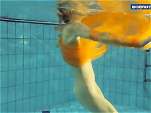 Yellow and red clothed teenage underwater